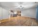 Wide view of an open living room showcasing wood floors that connect the kitchen, dining, and lounge areas at 3053 Riker St, Clover, SC 29710