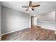 Open living room with hardwood floors, ceiling fan, and gray walls at 3053 Riker St, Clover, SC 29710