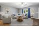 Cozy living room featuring a sectional sofa with blue accents, and natural light, perfect for relaxing and entertaining at 3053 Riker St, Clover, SC 29710
