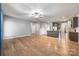 Spacious living room with an open layout, wood floors, ceiling fan, and access to the kitchen and dining area at 3053 Riker St, Clover, SC 29710