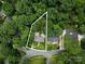 Aerial view of home surrounded by trees, including a private pool at 3225 Mill Pond Rd, Charlotte, NC 28226