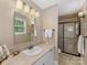 Well-lit bathroom with a tiled countertop, walk-in shower, and modern fixtures at 3225 Mill Pond Rd, Charlotte, NC 28226