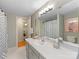 Well-lit bathroom with a spacious vanity, large mirror, and neutral tones at 3225 Mill Pond Rd, Charlotte, NC 28226