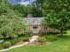Charming brick home with stone entryway and beautifully landscaped front yard at 3225 Mill Pond Rd, Charlotte, NC 28226