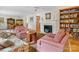 Cozy living room with a fireplace, built-in bookshelves, and hardwood floors at 3225 Mill Pond Rd, Charlotte, NC 28226