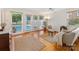 Open floor plan showcasing hardwood floors, large windows, and a view of the pool at 3225 Mill Pond Rd, Charlotte, NC 28226