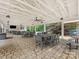 Covered patio with tables, chairs, ceiling fans, and brick flooring for outdoor gatherings at 3225 Mill Pond Rd, Charlotte, NC 28226