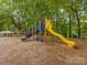 Colorful playground with a slide and climbing structure, nestled in a wooded area for outdoor fun at 3225 Mill Pond Rd, Charlotte, NC 28226