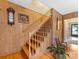 Inviting staircase with wood paneling and hardwood floors leads to the upper level of the home at 3225 Mill Pond Rd, Charlotte, NC 28226