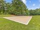 Outdoor volleyball court with a net on a sunny day, surrounded by green grass and trees at 3225 Mill Pond Rd, Charlotte, NC 28226