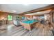 Recreational basement features exposed beams, pool table, brick accents and access to outdoor lake views at 3248 Lake Shore S Rd, Denver, NC 28037