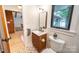 Cozy bathroom with modern vanity, updated fixtures, and patterned tile flooring at 3248 Lake Shore S Rd, Denver, NC 28037