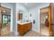 Bright bathroom with a modern vanity, ample lighting, and decorative patterned tile at 3248 Lake Shore S Rd, Denver, NC 28037