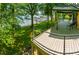 Covered wood deck overlooking the water with cable railings and plenty of space for outdoor furniture and entertaining at 3248 Lake Shore S Rd, Denver, NC 28037