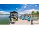 Lakeside dock with covered boat slip and a seating area, perfect for relaxing and enjoying the waterfront views at 3248 Lake Shore S Rd, Denver, NC 28037