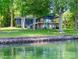 Lakefront home with a well-manicured lawn and multiple decks overlooking the water at 3248 Lake Shore S Rd, Denver, NC 28037