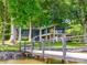 Stunning lakefront home with a private dock and beautiful landscaping in a tranquil, wooded setting at 3248 Lake Shore S Rd, Denver, NC 28037