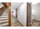 Hallway with wood accents, adjacent bathroom, and access to upper and lower levels at 3248 Lake Shore S Rd, Denver, NC 28037