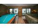 Relax in this living room with a pool table and lovely water views at 3248 Lake Shore S Rd, Denver, NC 28037