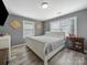This primary bedroom is decorated with wood-look flooring and gold accents at 339 Arnold St, Rock Hill, SC 29730