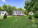 Quaint single-story house with lush green front lawn and established landscaping at 339 Arnold St, Rock Hill, SC 29730