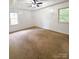 This is a cozy bedroom featuring plush carpet, neutral walls, and natural light at 3430 Fincher Blvd, Charlotte, NC 28269