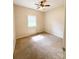 This is a simple bedroom featuring carpet, a window, and a ceiling fan at 3430 Fincher Blvd, Charlotte, NC 28269
