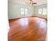 Bright and airy bedroom featuring hardwood floors and abundant natural light at 3430 Fincher Blvd, Charlotte, NC 28269