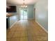 Dining area featuring tile floors, a modern chandelier, and sliding glass doors leading to a deck at 3430 Fincher Blvd, Charlotte, NC 28269
