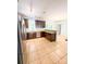 Spacious kitchen featuring stainless appliances, tile floors, and wood cabinets for a modern and clean feel at 3430 Fincher Blvd, Charlotte, NC 28269