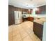 Bright kitchen featuring stainless appliances, tile floors, granite countertops, and ample storage in wooden cabinets at 3430 Fincher Blvd, Charlotte, NC 28269