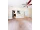 Empty living room featuring neutral walls, carpet flooring, a ceiling fan, and easy access to the kitchen at 3430 Fincher Blvd, Charlotte, NC 28269