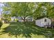 Large backyard with a shed, mature trees, and plenty of green space at 3721 Conway Ave, Charlotte, NC 28209