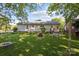 Spacious backyard featuring mature trees, a fire pit, and outdoor seating area at 3721 Conway Ave, Charlotte, NC 28209