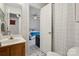 Bright bathroom with shower/tub combo that opens to a bedroom with ceiling fan at 3721 Conway Ave, Charlotte, NC 28209
