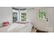Cozy bedroom featuring natural light, a comfortable bed, and minimalist decor at 3721 Conway Ave, Charlotte, NC 28209