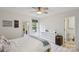 Bright bedroom with neutral walls, a ceiling fan, large window and en-suite bathroom at 3721 Conway Ave, Charlotte, NC 28209