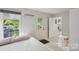 Cozy bedroom featuring natural light, exterior access, and a quaint workspace at 3721 Conway Ave, Charlotte, NC 28209