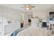 Bright bedroom with neutral walls, a ceiling fan, and views into en-suite bathroom and hallway at 3721 Conway Ave, Charlotte, NC 28209