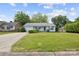 Inviting one-story home with lush lawn, a driveway, and charming curb appeal at 3721 Conway Ave, Charlotte, NC 28209
