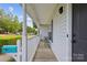 Charming front porch with wood flooring, seating, and a vibrant blue mailbox at 3721 Conway Ave, Charlotte, NC 28209
