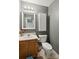 Well-lit half bathroom with modern fixtures, vanity, and convenient toilet placement at 3721 Conway Ave, Charlotte, NC 28209