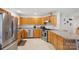 Well-lit kitchen featuring stainless steel appliances, wood cabinets, and a functional layout at 3721 Conway Ave, Charlotte, NC 28209