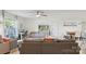 Bright living room with neutral tones, ceiling fan, large window, and view into dining area at 3721 Conway Ave, Charlotte, NC 28209