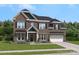 Charming two-story brick home with a well-manicured lawn and a two-car garage, offering classic curb appeal at 403 Balboa St, Matthews, NC 28104