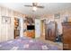 Cozy bedroom featuring wood paneling, a ceiling fan, and a unique decor at 4059 10Th Avenue Sw Dr, Hickory, NC 28602