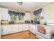 Functional kitchen with white cabinets, wood floors, and essential appliances at 4059 10Th Avenue Sw Dr, Hickory, NC 28602