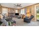 Cozy living room featuring carpet, wood paneling, fireplace, and a ceiling fan at 4059 10Th Avenue Sw Dr, Hickory, NC 28602