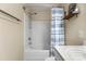 Clean bathroom featuring a shower-tub combo with a stylish blue striped curtain and floating shelf at 424 River Park Rd, Belmont, NC 28012