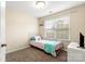 Comfortable bedroom with neutral walls, soft carpet, and a cozy twin bed near a bright window at 424 River Park Rd, Belmont, NC 28012